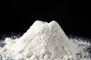 Close-up of natural coconut flour on a black background