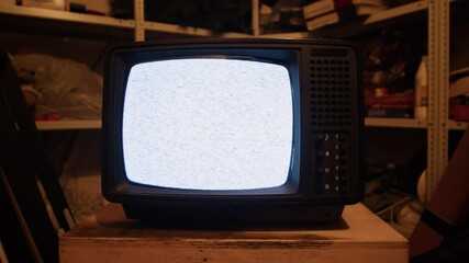 Retro TV, vintage television In a nostalgic setup, a retro TV displays grain on screen, scary halloween night device good for chroma key and green screen.
