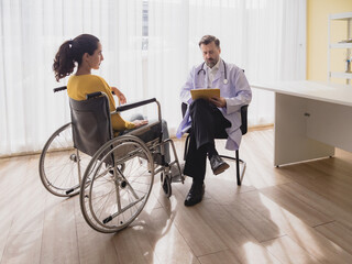 Health care latin woman sick sit wheelchair with man doctor caucasian two people check and treat...