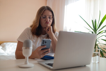 Worried fatigued mature business woman having headache at work. Tired busy 30s aged businesswoman feeling stress at home workplace looking at laptop computer in office. High quality photo