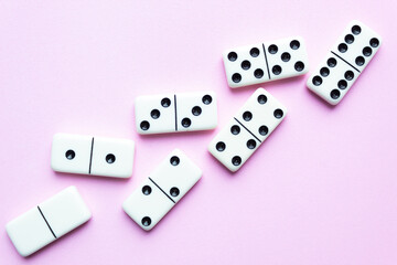 Domino tiles on pink background and space for text.