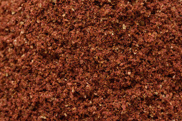 high resolution macro photography of dried and ground sumac seeds, a ready-made spice