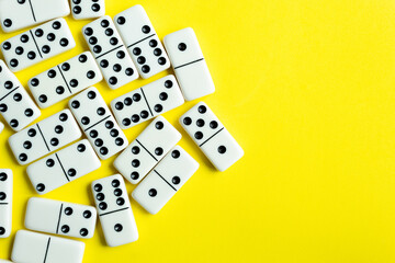 Domino tiles on yellow background and space for text.