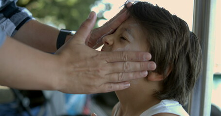 Gently spreading sunscreen on a child's face in slow motion at 800 fps, focusing on the careful and protective application to prevent sun damage