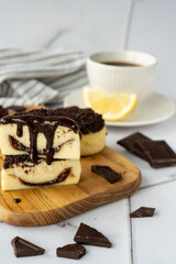 Mini Cheesecakes with Chocolate Crumble Topping Served on a Wooden Board, Accompanied by a Cup of Black Coffee. Concept of Indulgent Dessert, Coffee Break, and Sweet Treats in a Cozy Atmosphere.