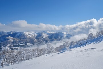 Stunning winter landscape overlooking snow-covered mountains beneath a blue sky