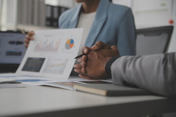 Close up of Business team analyzing income charts and graphs with modern laptop computer. Business analysis and strategy concept.