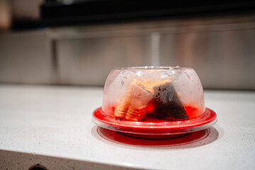 various types of sushi on conveyor belt in a Japanese restaurant. Shushi Go Round is a famous form of fast food in Asia, also known as sushi train.