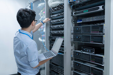 Computer engineer is setting up network in server room,Systems Maintenance Technician,Male engineer...