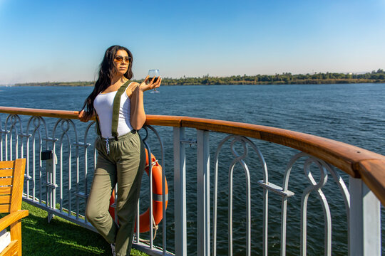 Sexy woman enjoying a captivating adventure on the Nile Nights. Let yourself be seduced by the mystique of ancient Egypt as you sail down the Nile, surrounded by breathtaking scenery and rich history.