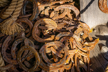 old rusty horseshoes lying on the farm. abandoned farm with equipment