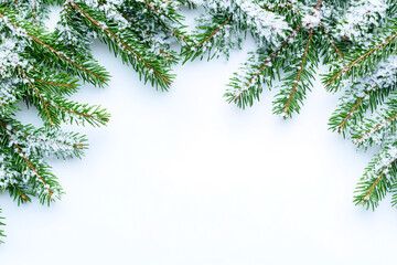 Christmas border frame with evergreen branches, holly berries, and candy canes on a white background. Vector illustration of a winter floral border for a greeting card or poster design.