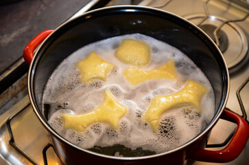 Donuts frying in deep fat. Preparation of traditional donuts