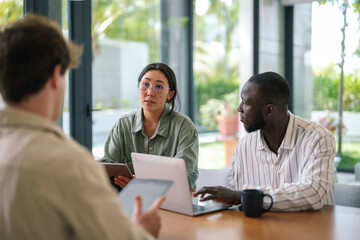 Multicultural Team Engaged in Strategy Session with Digital Tools