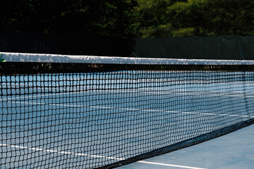 Tennis Court With Net Under The Bright Sunny Sky