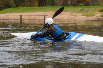 Kayak slalom canoe race in river. Kayaking  with colorful canoe kayak boat.  Paddling, process.