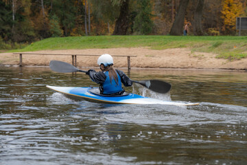 Kayak slalom canoe race in river. Kayaking  with colorful canoe kayak boat.  Paddling, process.