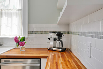 Modern Kitchen With Wooden Countertops And Flowers.