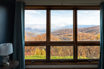 Rustic apartment home with bedroom window view of Wintergreen Resort, Virginia blue ridge mountains in autumn fall season
