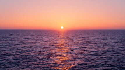 Obraz premium Beautiful sunset on the ocean shore with orange and pink clouds.