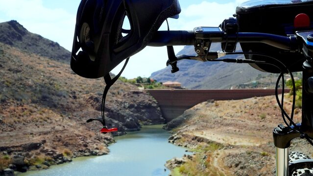 Ayagaures Dam in Canary Islands with low water level seen from a mountain top visitable by bike