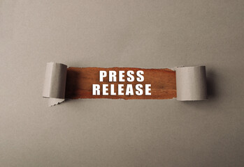 A torn piece of paper with the words press release written on it