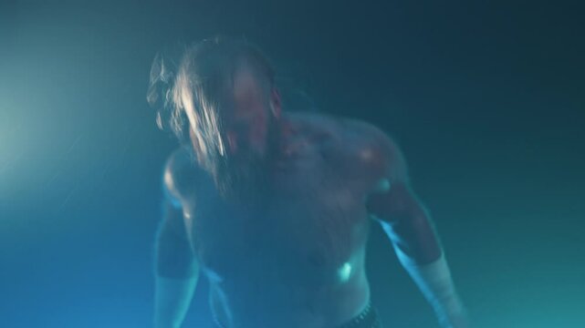An aggressive pro wrestler taunting the camera