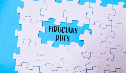 Fototapeta premium A jigsaw puzzle piece with the phrase Fiduciary Duty prominently displayed in the center