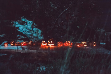 Spooky Halloween Night with Glowing Jack-o-Lanterns illuminating the darkness