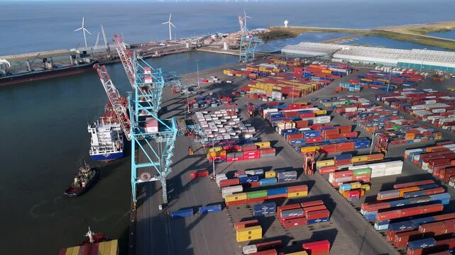 A busy container port in Liverpool with a large cargo ship being loaded.