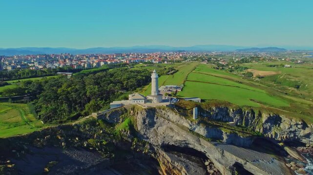 Aerial view of the Cape Mayor lighthouse (Faro de Cabo Mayor) on the rocky coast in Santander, Spain.
