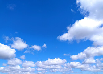 Clear blue sky texture and white fluffy cloud nature background. The sun shines bright in the daytime in summer