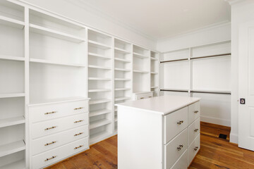Spacious Walk-In Closet With Shelving And Wooden Floors