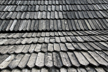 The old building is covered with wooden tiles