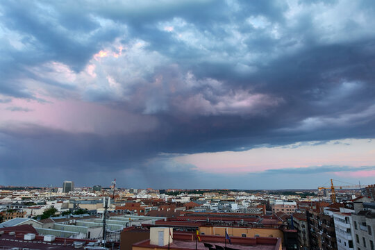 Dusk with colorful clouds and a storm on the horizon, on the outskirts of the city of Madrid, Spain