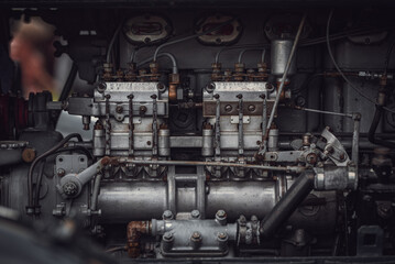 Old tractor diesel engine on a display under the motor cover.