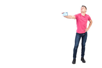 Joyful young male pouting lips and taking selfie against white background