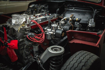 Engine under the bonnet of a classic motor which undergoing full restoration