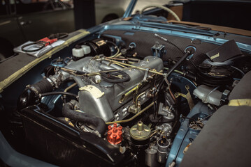 Engine under the bonnet of a classic motor which undergoing full restoration