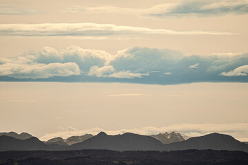 A beautifully cloudy sky with majestic mountains in the background