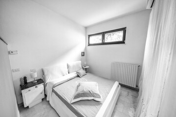 Nice warm interior of a bed and breakfast bedroom with white walls and nightstands