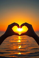 The silhouette of two hands creating a heart shape is set against a stunning ocean sunset, conveying themes of unity, connection, and the boundless warmth of love.