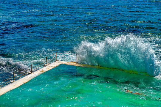 Bondi Beach, New South Wales. Sea Waves crushing on the famous pools along the ocean on a stormy morning