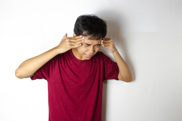 teenager with headache holding his head