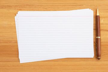 Blank index cards with a pen on a desk