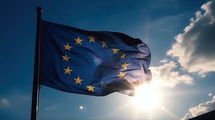 European Union flag waving against blue sky at sunset
