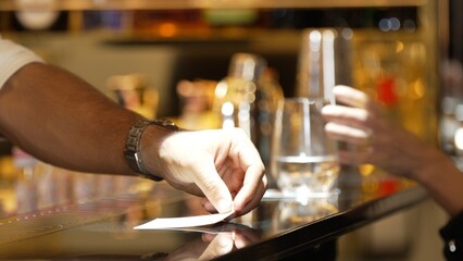 Closeup bartender hand in poring fresh soda gas texture into glass of drink advertisement serving customer at beverage bar counter luxury pub for welcome impression greeting guess service. Vinosity.