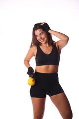 young smiling woman with yellow kettlebell in front of white background