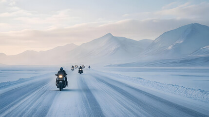 A motorcycle convoy on a remote icy highway in the Arctic with snow-covered mountains in the distance.