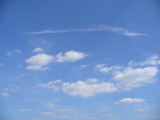 Fototapeta premium Blue clear sky with small white clouds - natural background. Topics: weather, meteorology, atmosphere, air space, day